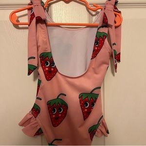 Hugo loves Tiki strawberry swimsuit. Super cute. only worn once!